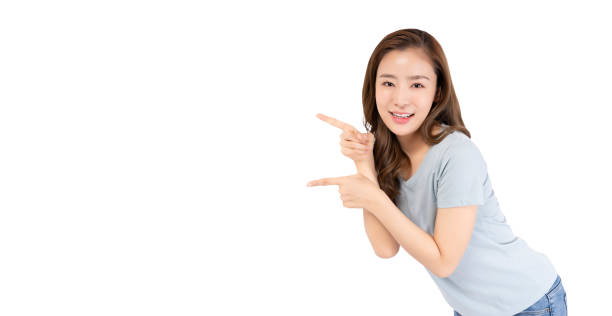 istock Smiling Woman Pointing on White Background 2158113172