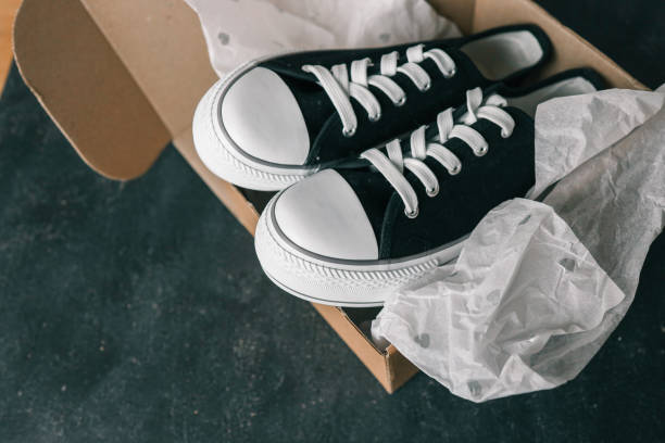 istock Black and white sneakers on a black background 2158113348
