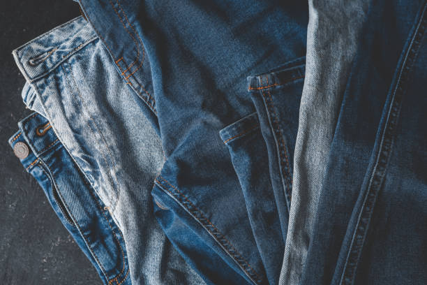 istock Stack of Various Shades Of Blue Jeans On White Background Denim jeans texture 2158113373