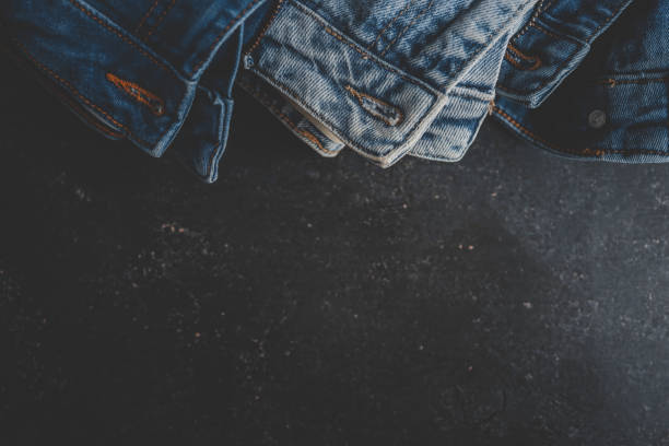 istock Stack of Various Shades Of Blue Jeans On White Background Denim jeans texture 2158113377