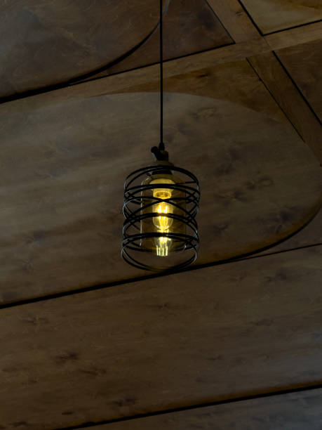 istock On the wooden ceiling hangs an elegant metal lamp 2158113486