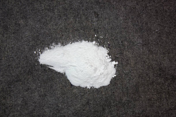 istock Drug, a powder. Powdered narcotic substance on a black background 2158113619