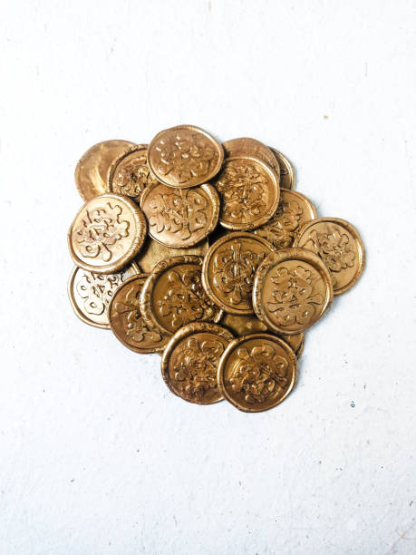 a lot of different types of coins on a white background