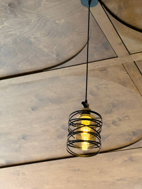 istock Elegant metal lamp on a wooden ceiling 2158113703
