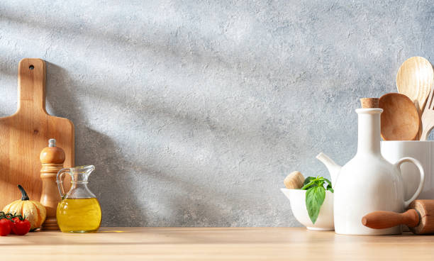 istock Wooden kitchen countertop with utensils and copy space. Abstract gray background 2158116527