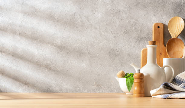 istock Wooden kitchen table with utensils and copy space. Abstract gray background 2158116529