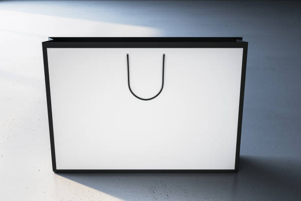 istock A blank white shopping bag with black handles stands against a textured background, suggesting a concept for branding or design mockup. 3D Rendering 2158116743