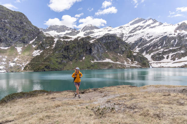 istock Hiker Enjoying the View of Mountain Lake 2158116793