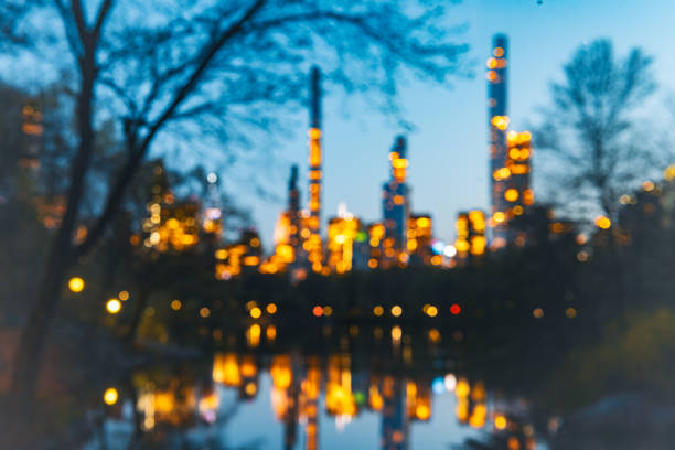 This is a view of the NYC Skyline at dusk reflected in the lake waters at Central Park in spring.