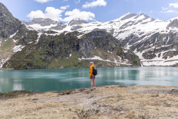 istock Hiker Admiring Mountain Lake 2158117187