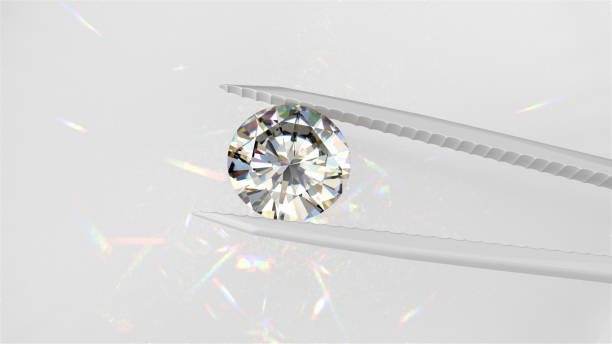 istock Brilliant Cut Diamond Held by Tweezers 2158117302