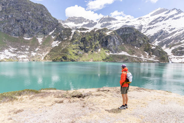 istock Adventurous Hiker Admiring Mountain Lake 2158117709