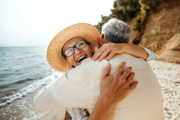 istock Mature couple embracing while spending a day on a beach 2158120523