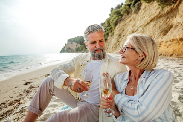 istock Mature couple enjoying picnic on a beach 2158121088
