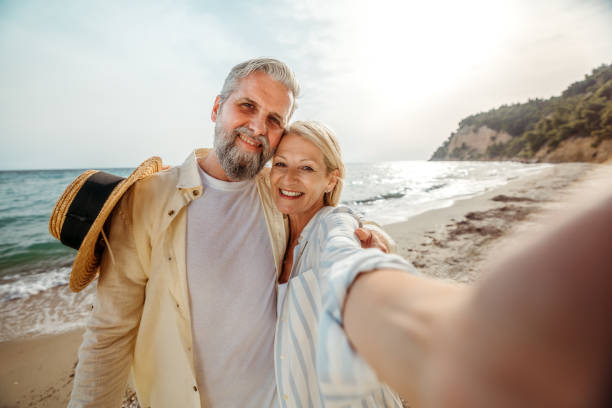 istock Mature couple taking a selfie while enjoying day on a beach 2158121117