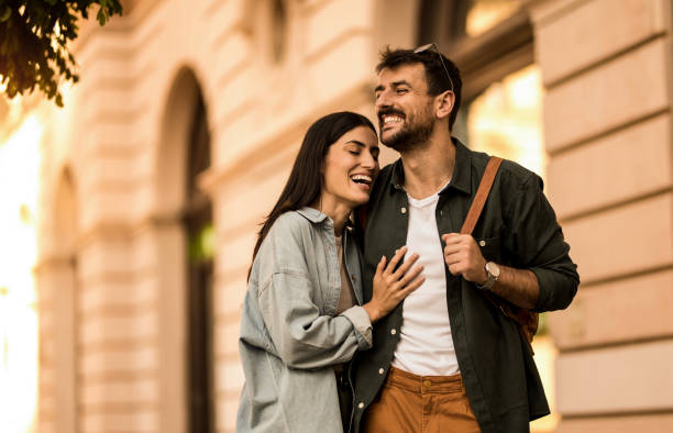 istock Happy young couple having fun while on a walk in the city. 2158121999