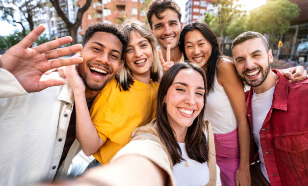 istock Multicultural cheerful friends taking selfie pic with smart mobile phone device - Youth community people laughing at camera together - Friendship concept with guys and girls having fun outdoors 2158122048