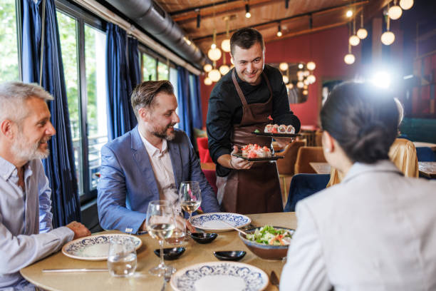 istock Business colleagues dining together in a modern restaurant 2158122245