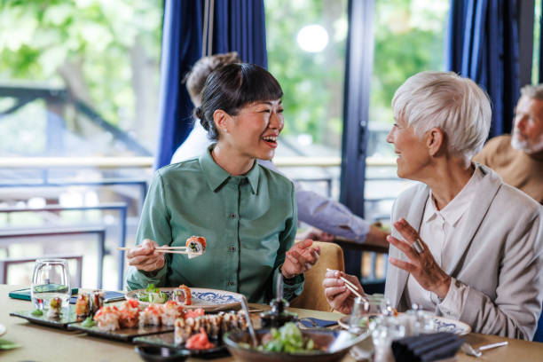 istock Two women enjoying sushi together at a restaurant 2158122301