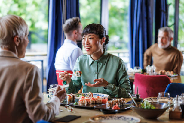 istock Friends enjoying sushi at a restaurant together 2158122305