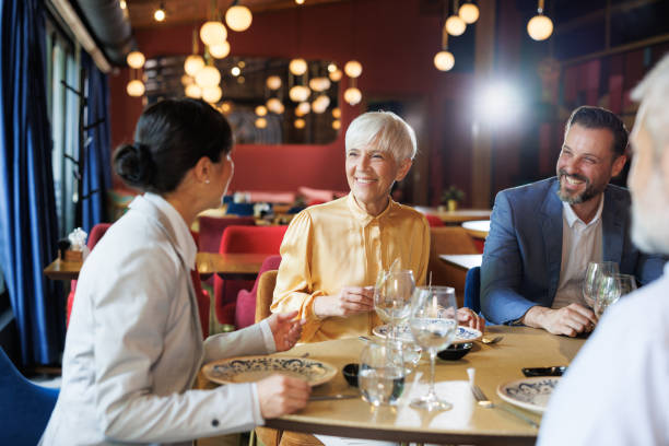 istock Business colleagues enjoying a conversation at a restaurant 2158122324