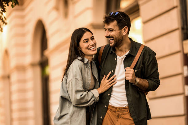 istock Happy young couple having fun while on a walk in the city. 2158122438