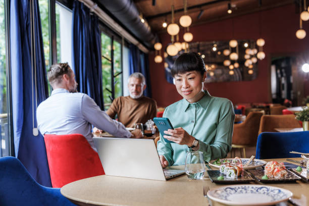 Businesswoman working on laptop at a restaurant