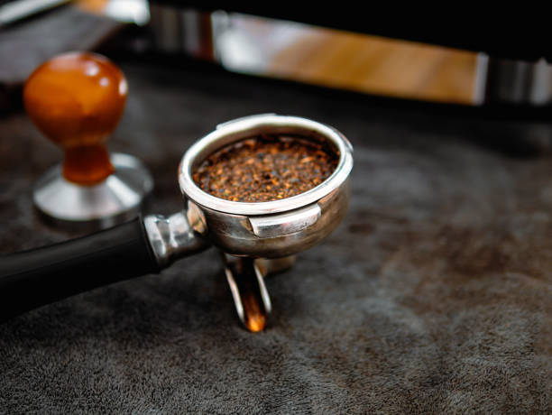 istock Portafilter or portable coffee filter handle and ground coffee for a coffee making machine on coffee shop 2158122666