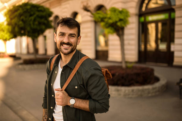 istock Close-up of happy young man looking at camera while exploring the city. 2158123295