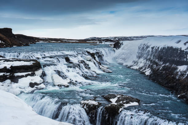 Beautiful Gullfoss waterfall flowing in Hvita river canyon during winter on gloomy day at Southwest Iceland