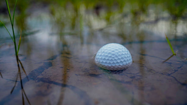 istock golf ball in water hazard. 2158123858