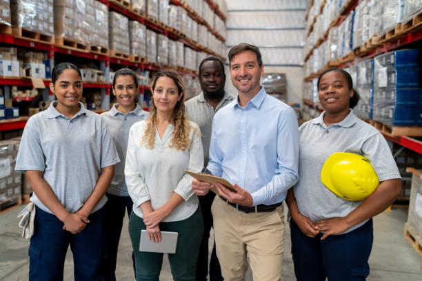 istock Group of employees working at a distribution warehouse 2158124281