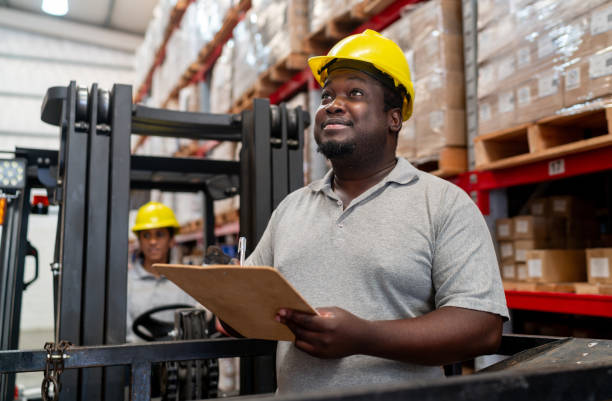 istock Worker taking inventory of the merchandise while working at a warehouse 2158124345