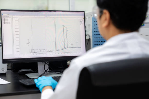 istock Researchers Using GC-MS Equipment for Sample Analysis in Testing Room. Compare the results with existing library standards, ensuring precision and accuracy in their scientific endeavors. 2158124623