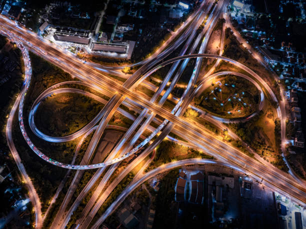 istock Expressway top view, Road traffic an important infrastructure, Drone aerial view fly in circle, traffic transportation, Public transport or commuter city life concept of economic and energ, transport. 2158126036
