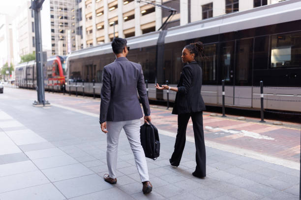 istock Two businesspeople talking about something while walking in the modern city 2158126658