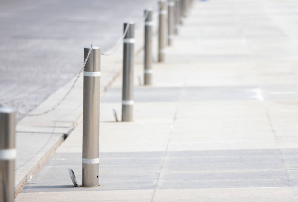 A row of metal poles with chains hanging from them. The scene is empty and quiet