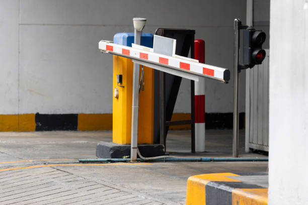 istock A red and white traffic light is on the side of a road. automatic barrier bar. 2158128670