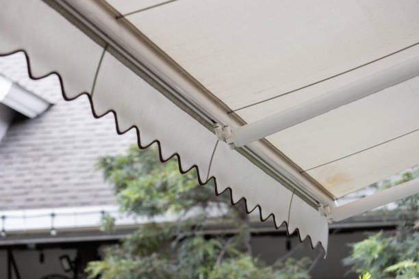 istock A white awning with a brown trim is hanging over a patio 2158128711