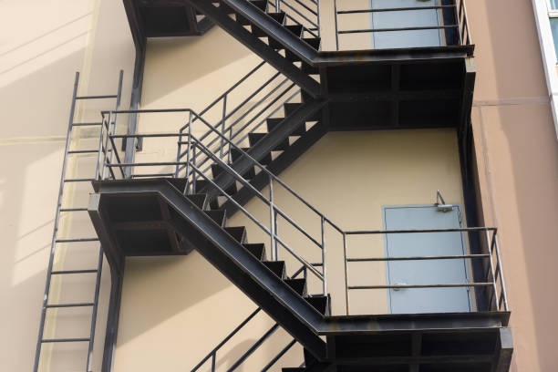 istock A building with a fire escape that has a ladder and stairs 2158128827