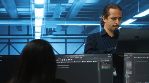istock Portrait of smiling manager using laptop, supervising team in server hub 2158130431