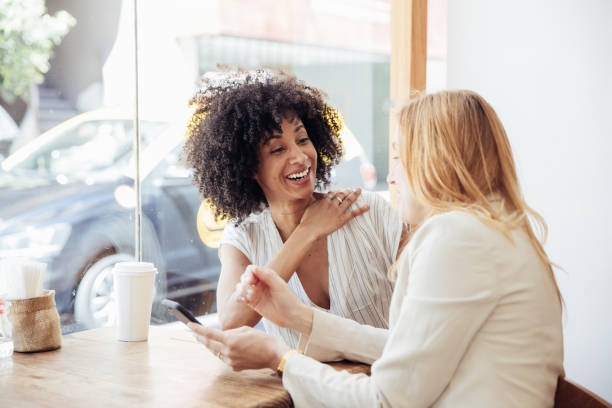 istock Two young businesswomen taking a break in a cafe. 2158130823