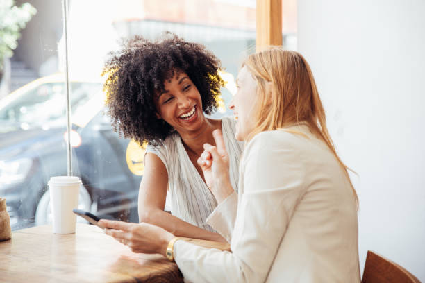 istock Two young businesswomen taking a break in a cafe. 2158130865