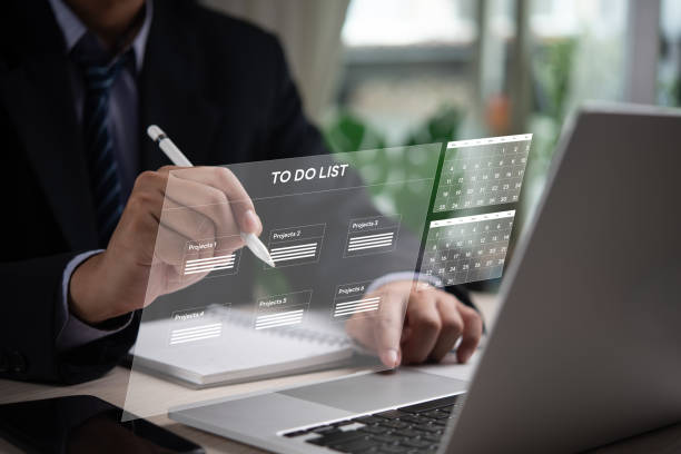 istock Businessman organizing tasks on digital to-do list, calendar interface. Represents project management, productivity, effective planning. Ideal for business organization, time management visuals. 2158132134