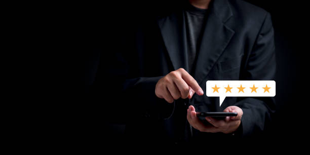 Businessman using smartphone to give five-star rating. Highlights customer satisfaction, service feedback, quality evaluation. Suitable for mobile review, digital interaction themes.