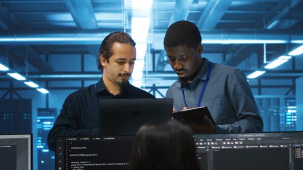 istock Diverse team of admins supervising data center supercomputers 2158132365