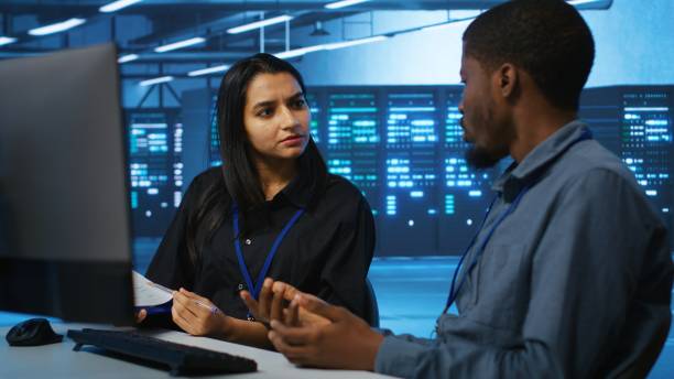 istock Coworkers in data center looking over annual systems review documents 2158132542