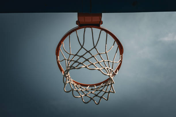 istock Low angle view of a basket hoop  on a sunny summer day. 2158132934
