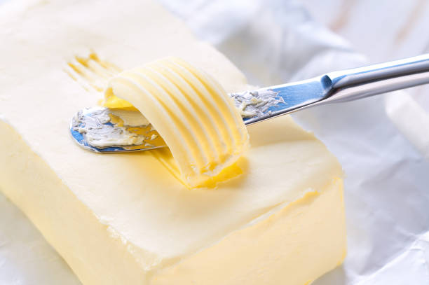 istock knife slicing through butter close up. 2158134942