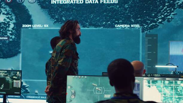 istock Military surveillance officers talk next to big screen in general headquarters 2158135249